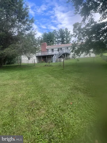 a view of a house with a backyard