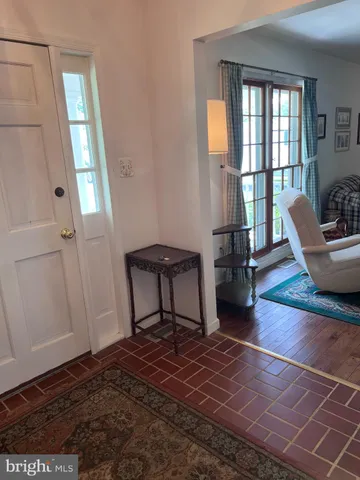 a living room with furniture a window and wooden floor