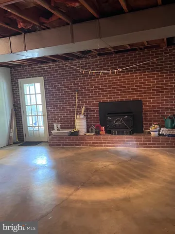 a view of empty room with fireplace and window