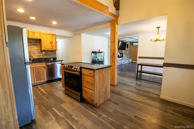 a kitchen with stainless steel appliances granite countertop a stove and a refrigerator