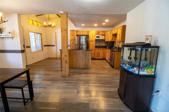a kitchen with stainless steel appliances granite countertop a refrigerator and a sink