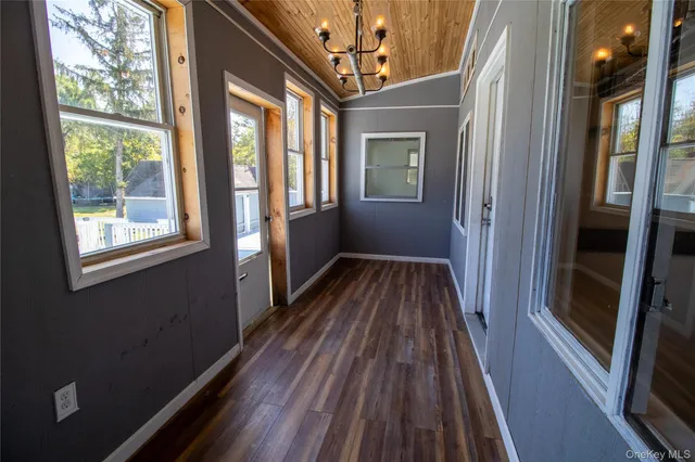 a view of a house with a yard patio and tree