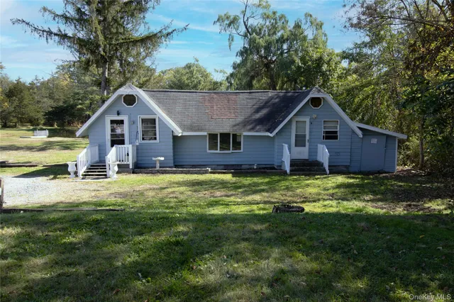 an empty room with windows and fireplace
