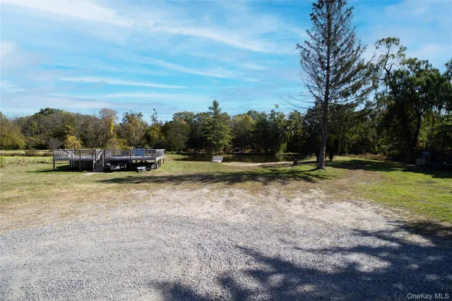 an aerial view of a house with a yard and lake view
