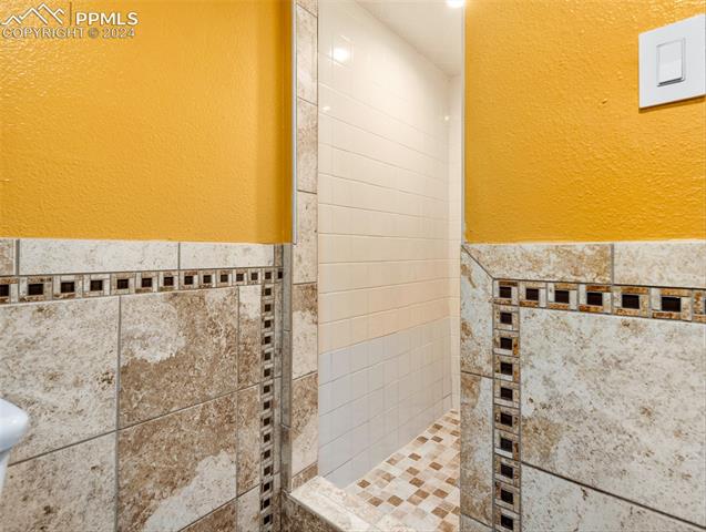 142 Mac Neil Road Pueblo, CO 81001 - Photo 19 of 24 Bathroom with a tile shower and toilet