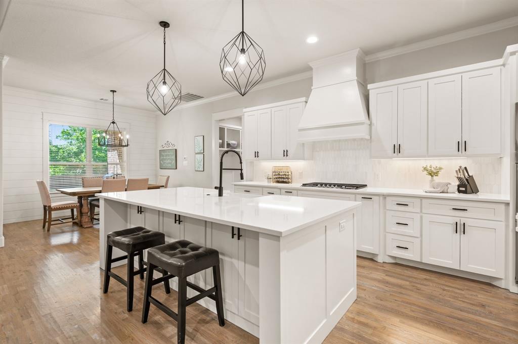 200 Clayton Crossing Springtown, TX 76082 - Photo 5 of 40 a kitchen with a white cabinets and chairs in it