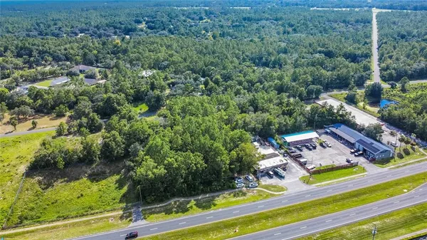 an aerial view of a house with swimming pool patio and lake view