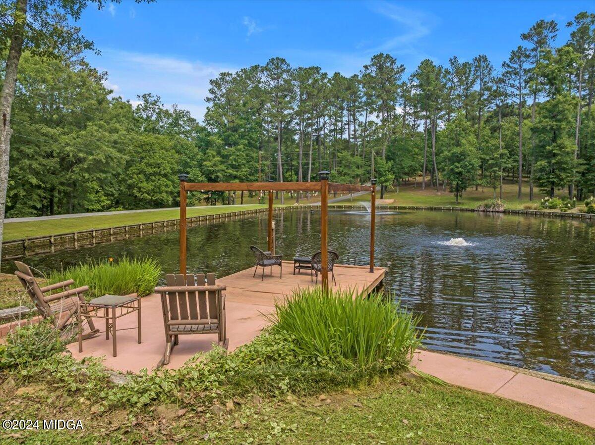 474 Plantation Road Gray, GA 31032 - Photo 11 of 64 a view of a lake with a bench in a yard