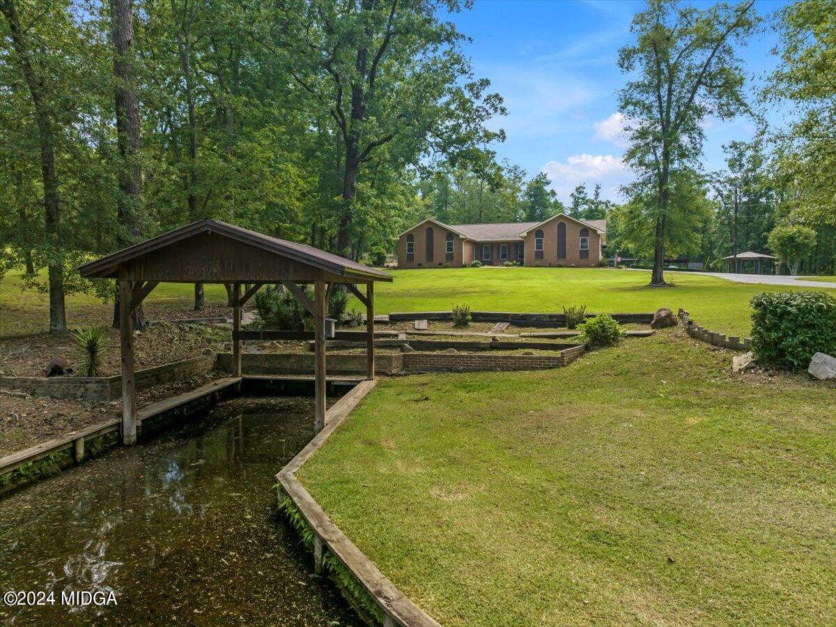 474 Plantation Road Gray, GA 31032 - Photo 12 of 64 a view of a swimming pool with a yard
