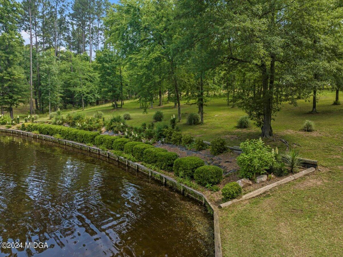 474 Plantation Road Gray, GA 31032 - Photo 15 of 64 a view of a garden with a lake