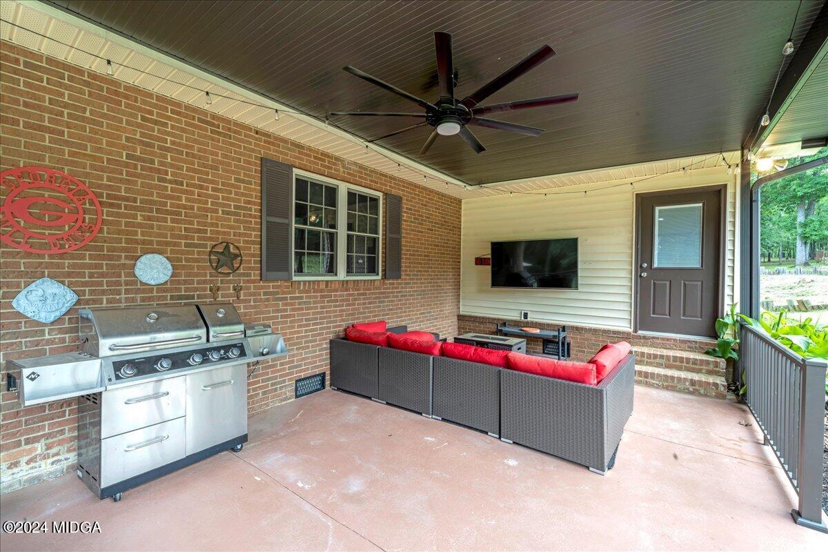474 Plantation Road Gray, GA 31032 - Photo 28 of 64 a living room with kitchen furniture and a flat screen tv