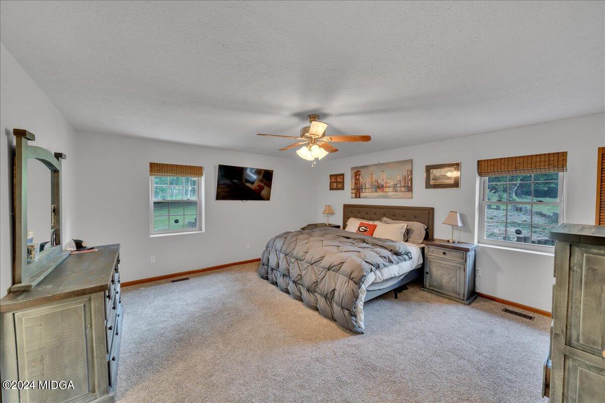 474 Plantation Road Gray, GA 31032 - Photo 37 of 64 a bedroom with a bed dresser and a window