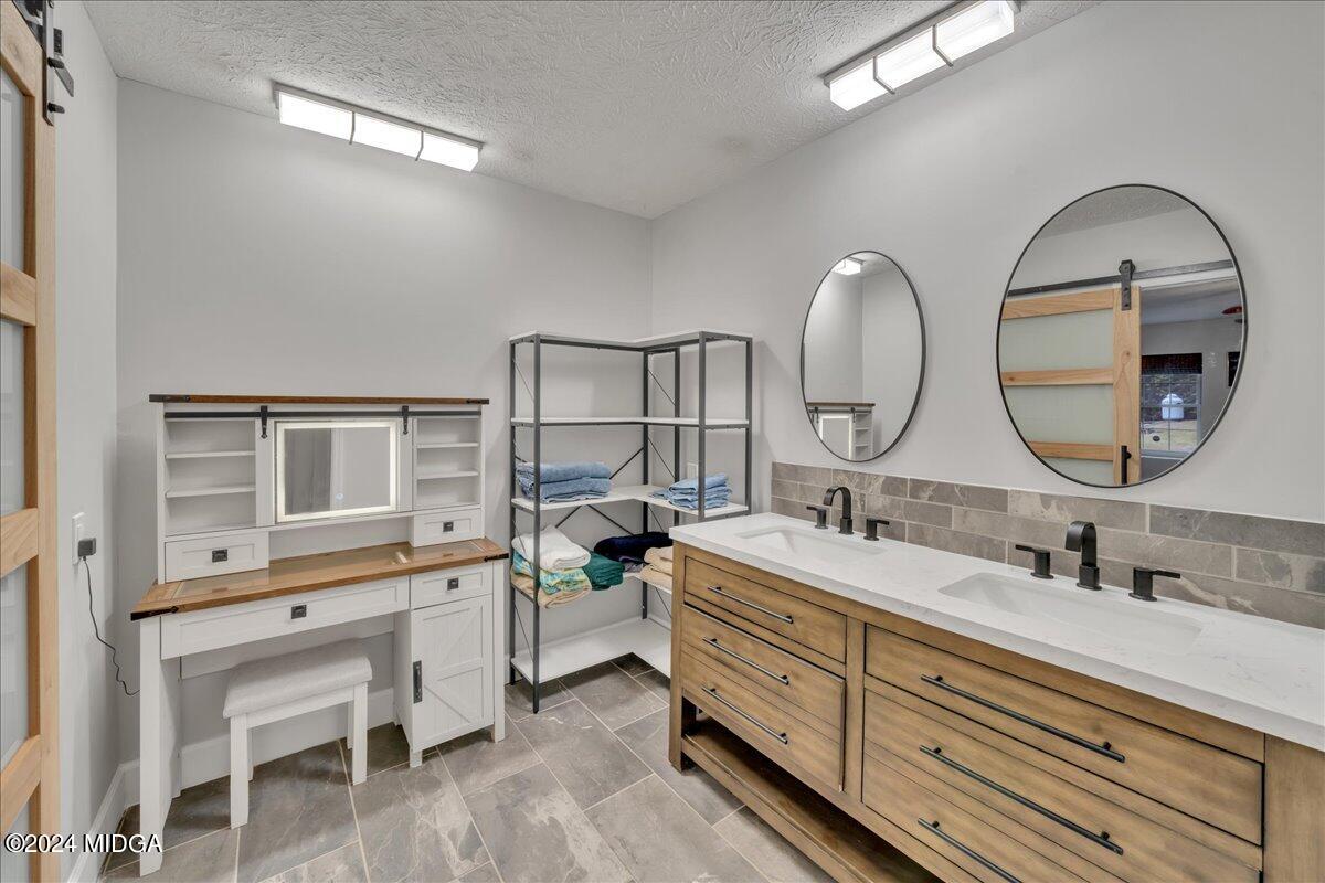 474 Plantation Road Gray, GA 31032 - Photo 39 of 64 a spacious bathroom with a double vanity sink and a mirror