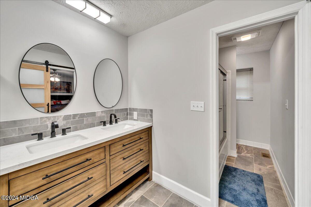 474 Plantation Road Gray, GA 31032 - Photo 40 of 64 a bathroom with a double vanity sink and a mirror