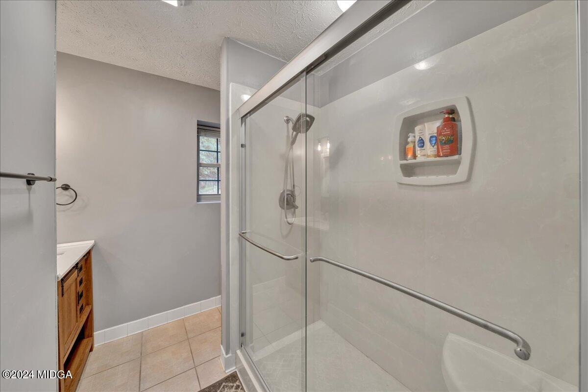 474 Plantation Road Gray, GA 31032 - Photo 44 of 64 a bathroom with a shower and a glass door