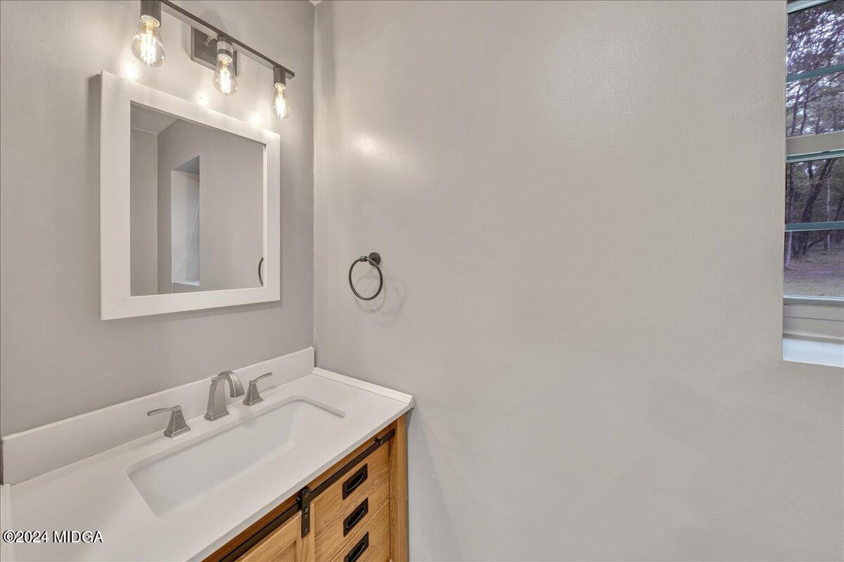 474 Plantation Road Gray, GA 31032 - Photo 45 of 64 a bathroom with a sink and a mirror