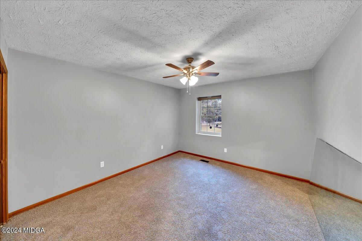 474 Plantation Road Gray, GA 31032 - Photo 46 of 64 an empty room with windows and fan
