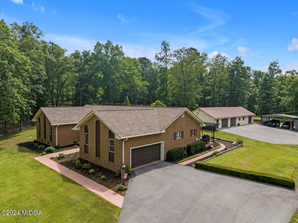 474 Plantation Road Gray, GA 31032 - Photo 48 of 64 an aerial view of a house with swimming pool and large trees