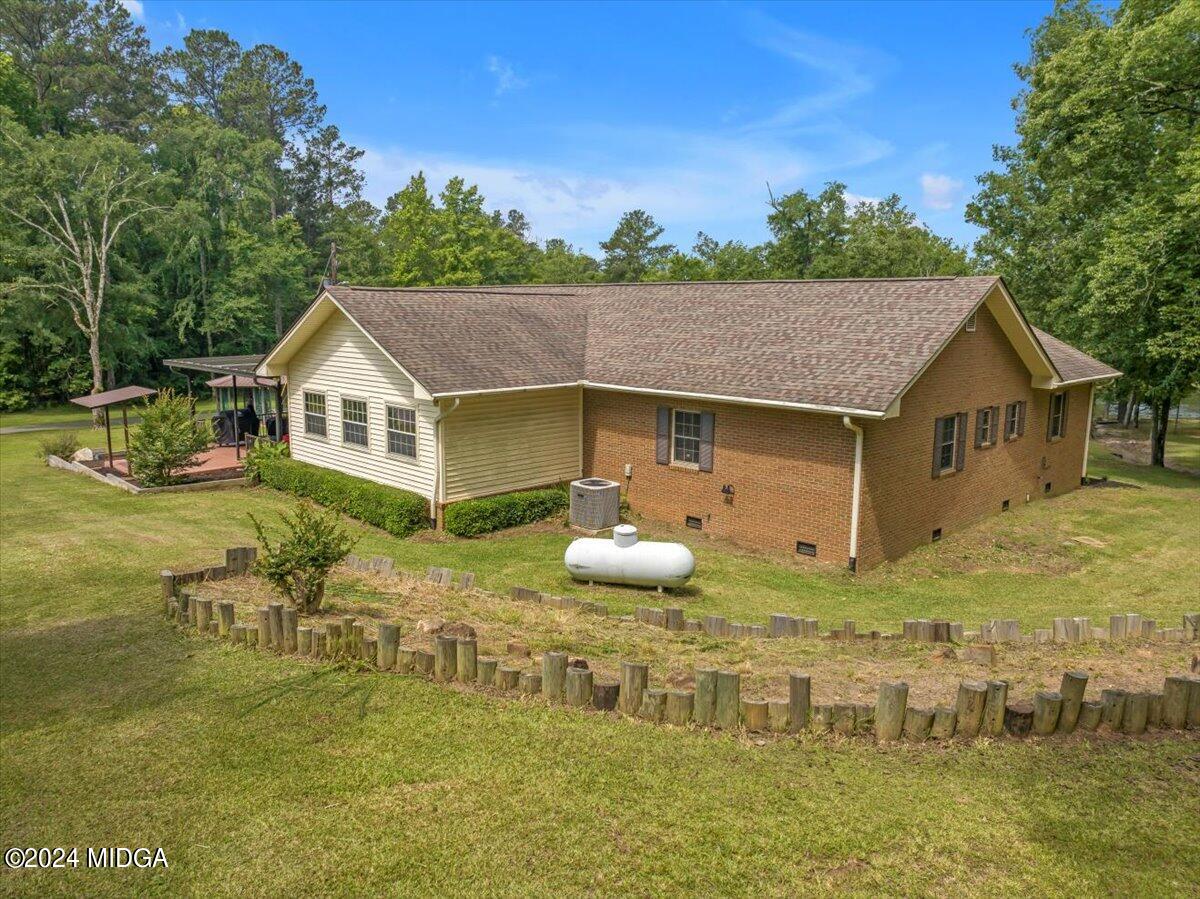 474 Plantation Road Gray, GA 31032 - Photo 58 of 64 a aerial view of a house with swimming pool and green space