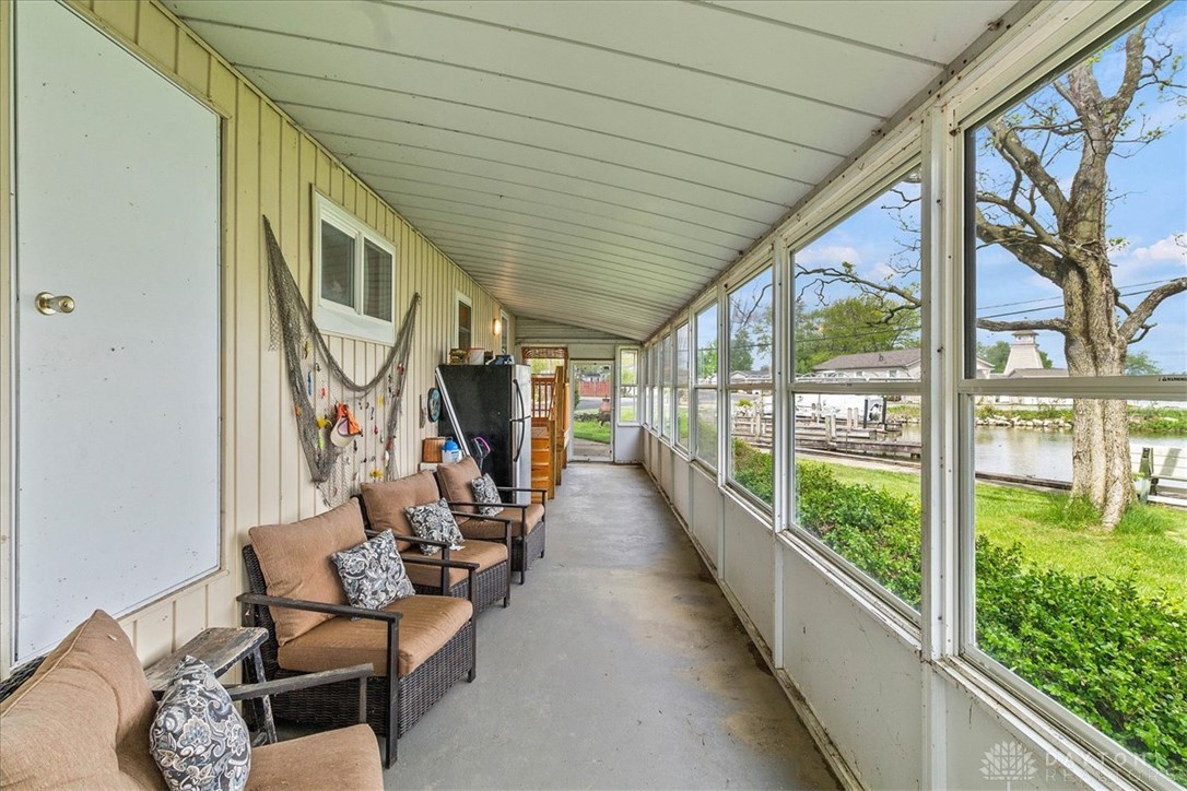 246 North Orchard Island Road Russells Point, OH 43348 - Photo 6 of 43 This enclosed porch offers panoramic water views, perfect for peaceful enjoyment.