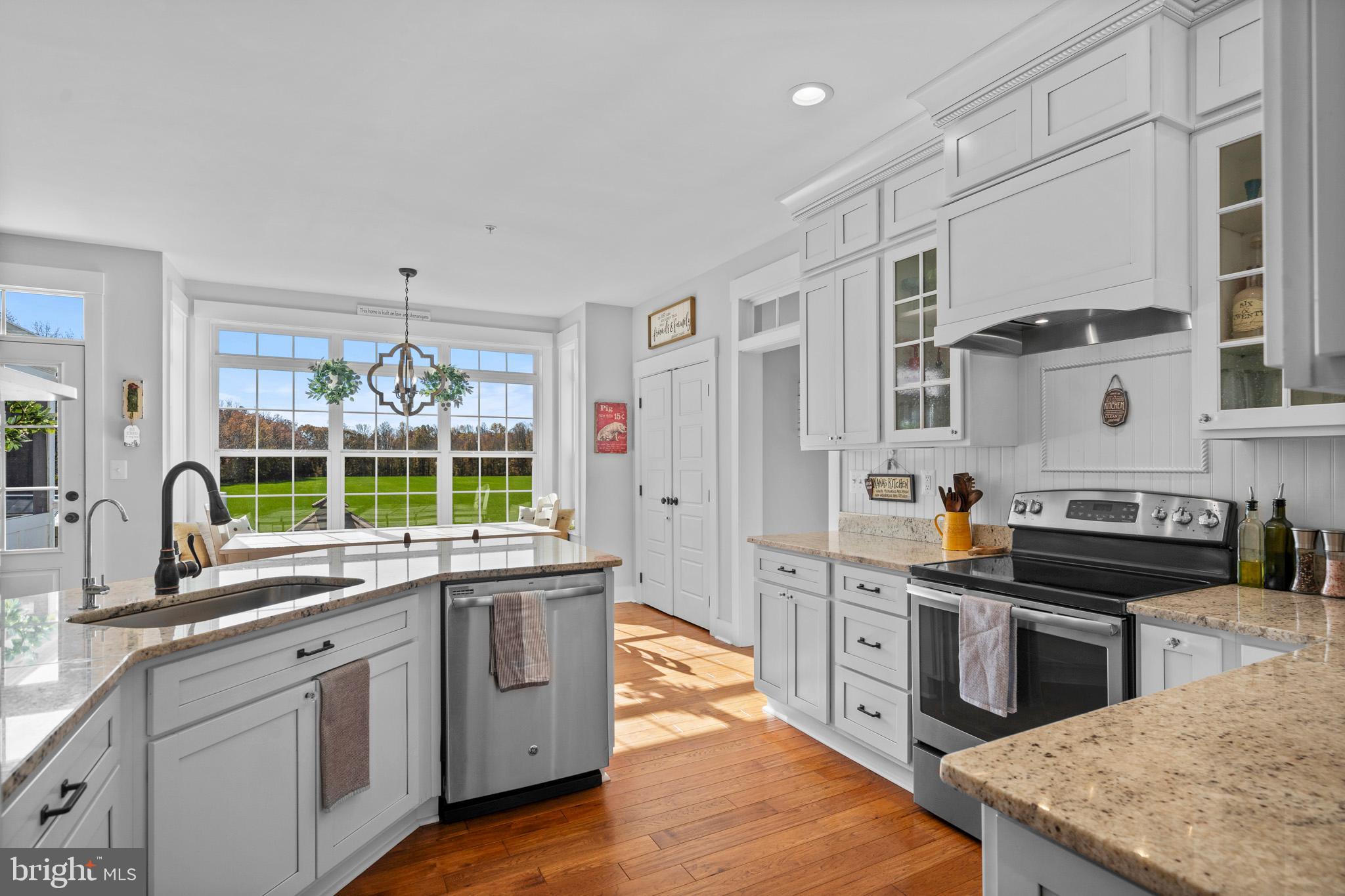1965 Lowery Road Huntingtown, MD 20639 - Photo 13 of 54 a kitchen with stainless steel appliances granite countertop a stove a sink and a granite counter tops with white cabinets