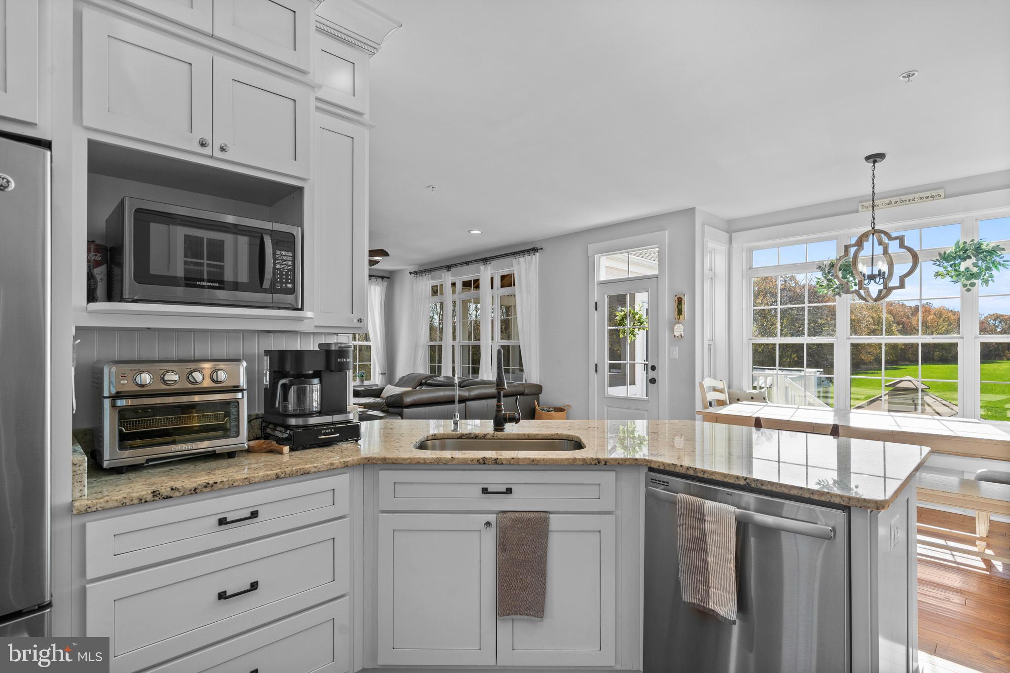 1965 Lowery Road Huntingtown, MD 20639 - Photo 15 of 54 a kitchen with stainless steel appliances granite countertop white cabinets and window