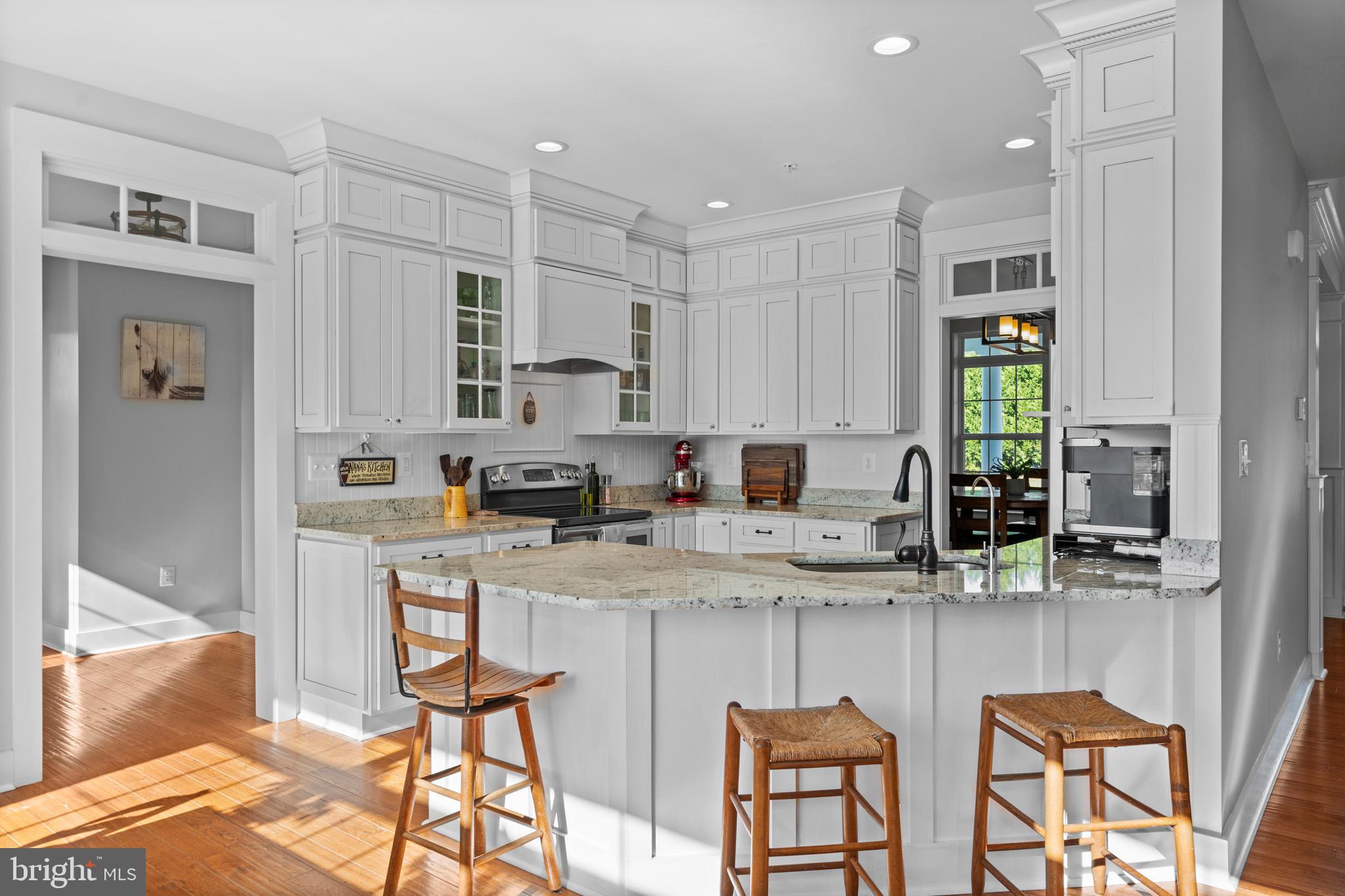 1965 Lowery Road Huntingtown, MD 20639 - Photo 18 of 54 a kitchen with stainless steel appliances granite countertop a table and chairs in it
