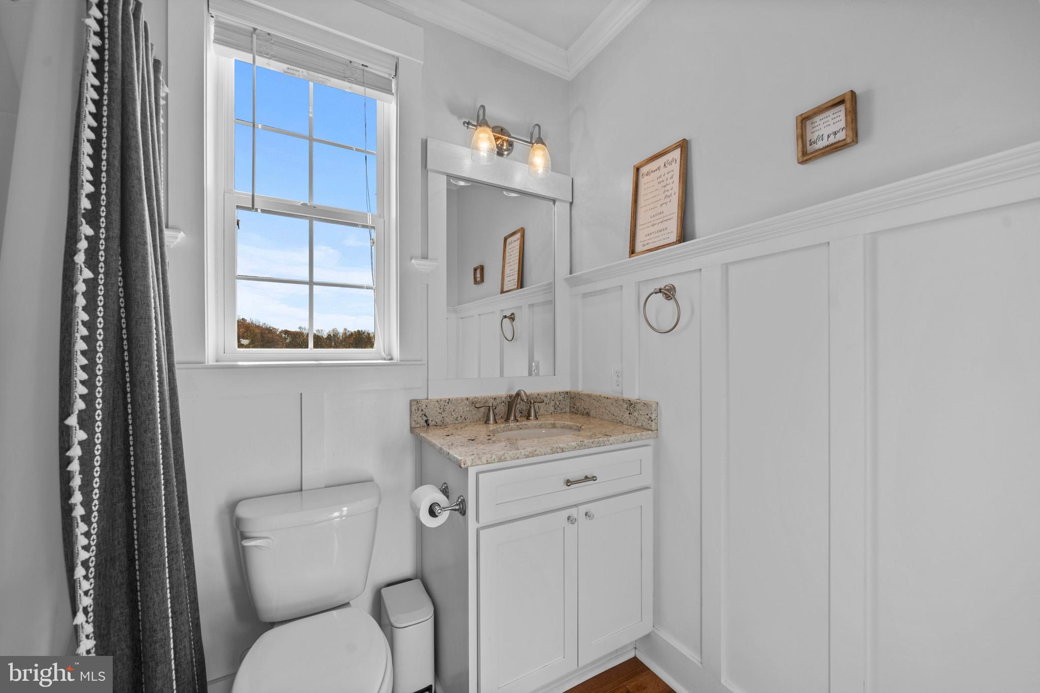 1965 Lowery Road Huntingtown, MD 20639 - Photo 26 of 54 a bathroom with a granite countertop toilet sink and mirror