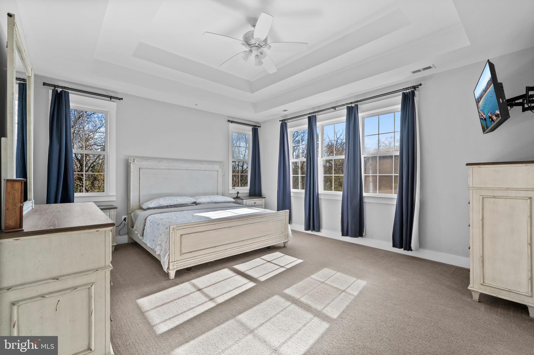 1965 Lowery Road Huntingtown, MD 20639 - Photo 27 of 54 a bedroom with a large bed and a chandelier