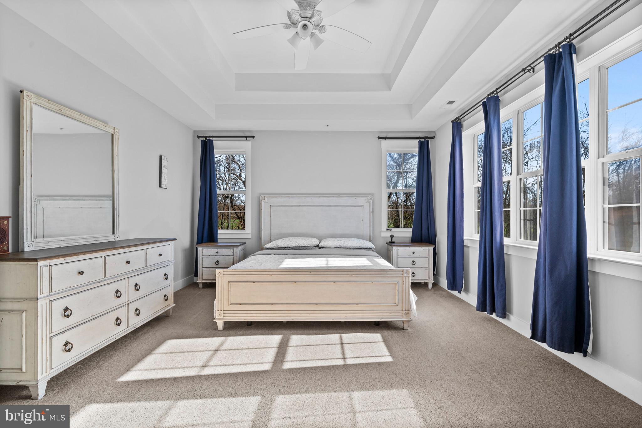 1965 Lowery Road Huntingtown, MD 20639 - Photo 29 of 54 a bedroom with a large bed and a chandelier