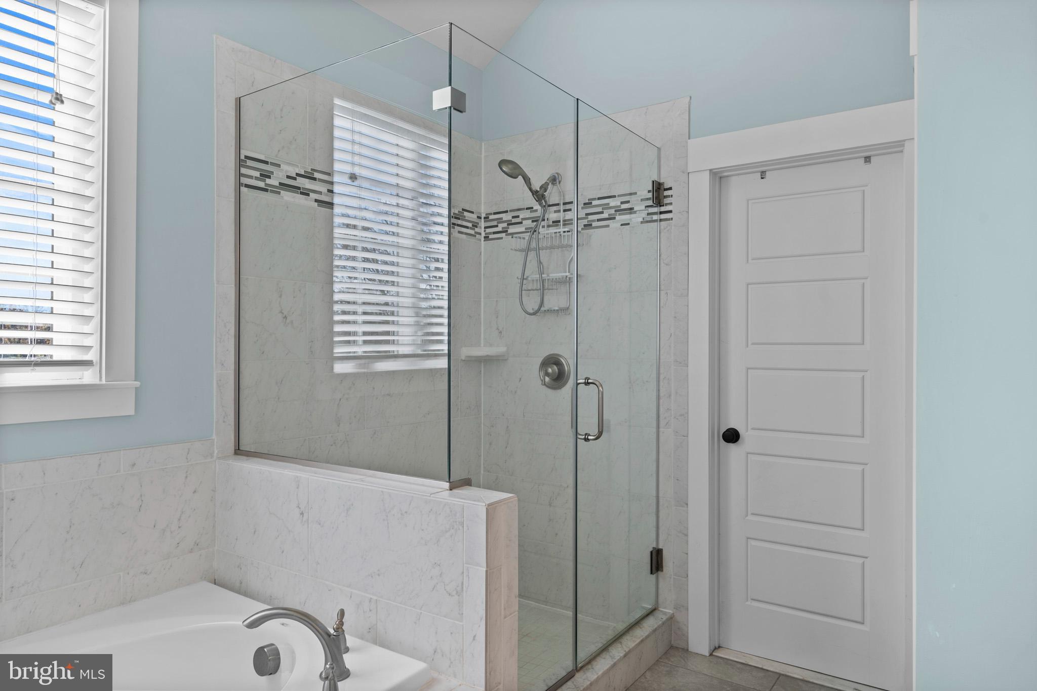 1965 Lowery Road Huntingtown, MD 20639 - Photo 34 of 54 a bathroom with a shower a window and a glass door