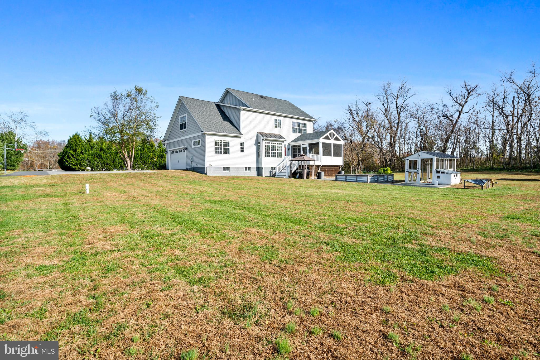 1965 Lowery Road Huntingtown, MD 20639 - Photo 49 of 54 a front view of a house with a garden and trees