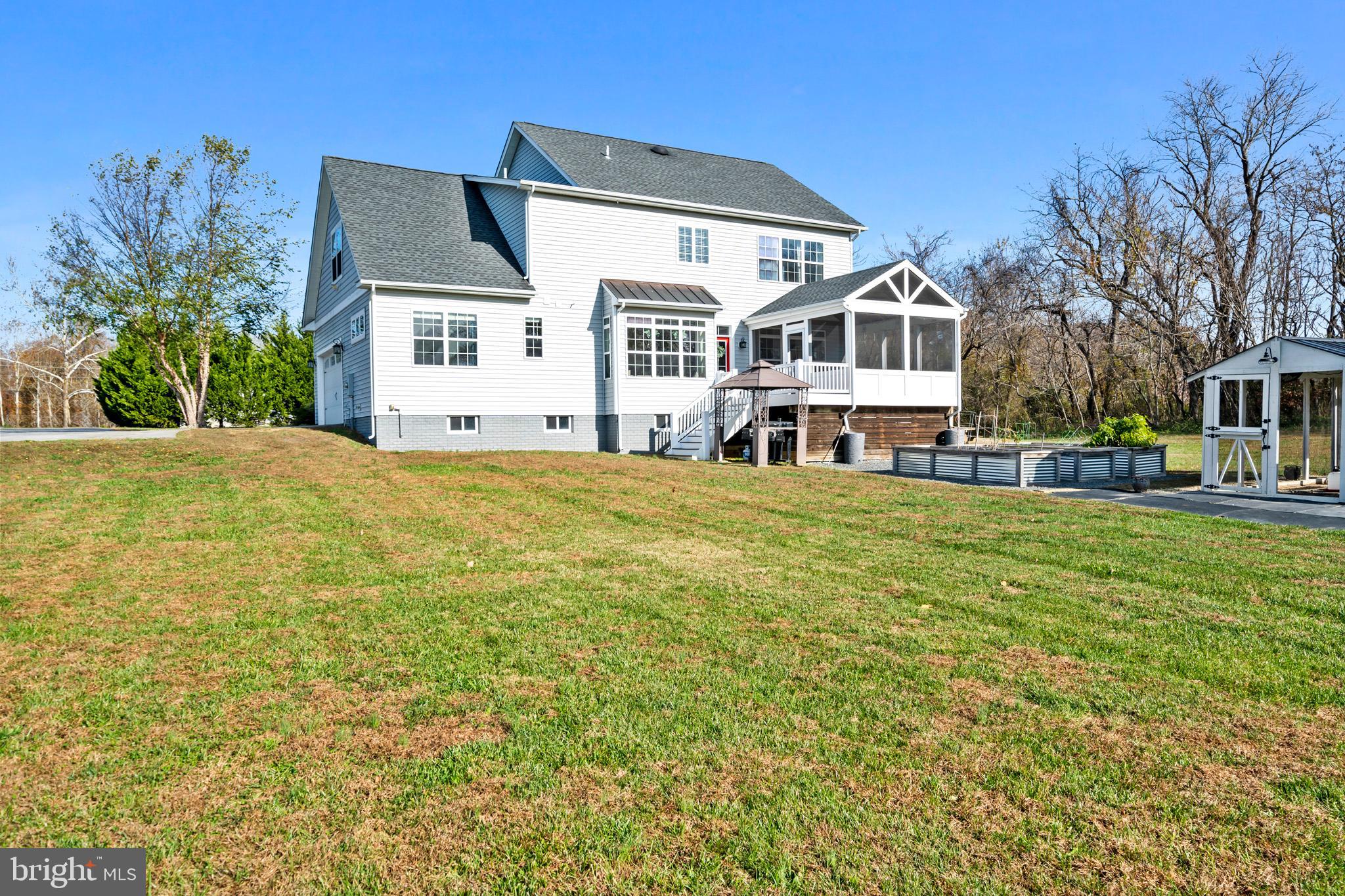 1965 Lowery Road Huntingtown, MD 20639 - Photo 50 of 54 a front view of a house with a garden