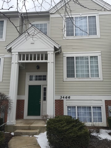 3466 Ravinia Circle, Unit 3466 Aurora, IL 60504 - Photo 1 of 24 a front view of a house with a garden