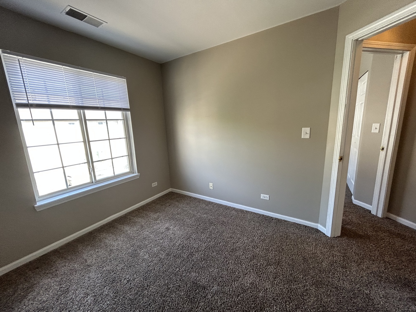 3466 Ravinia Circle, Unit 3466 Aurora, IL 60504 - Photo 11 of 24 an empty room with windows