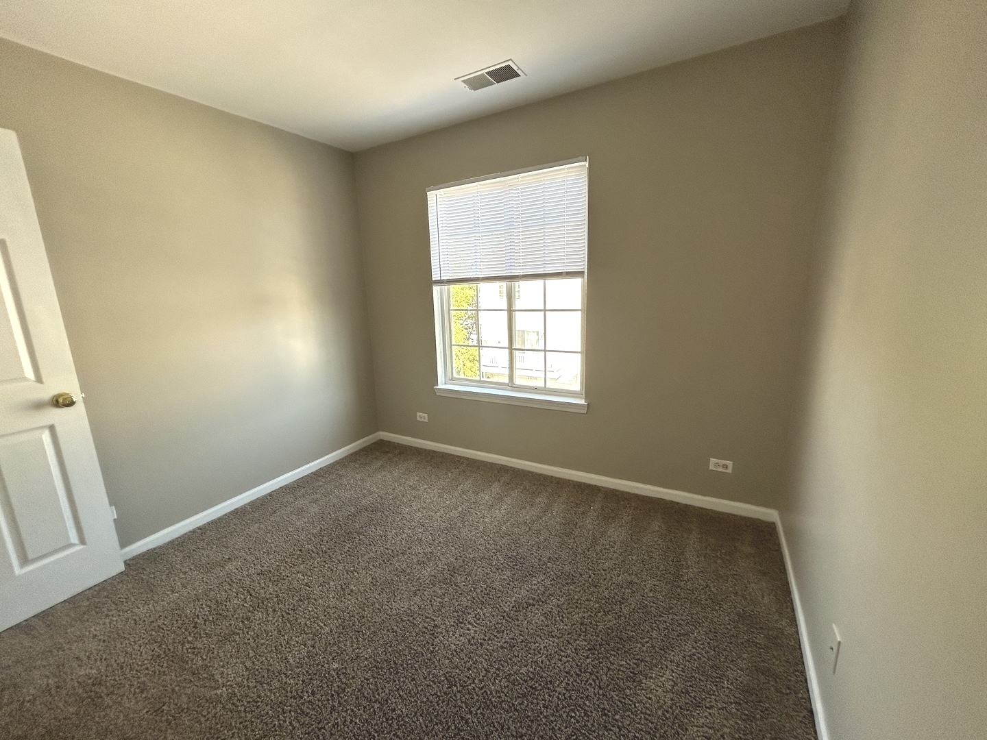3466 Ravinia Circle, Unit 3466 Aurora, IL 60504 - Photo 13 of 24 an empty room with windows