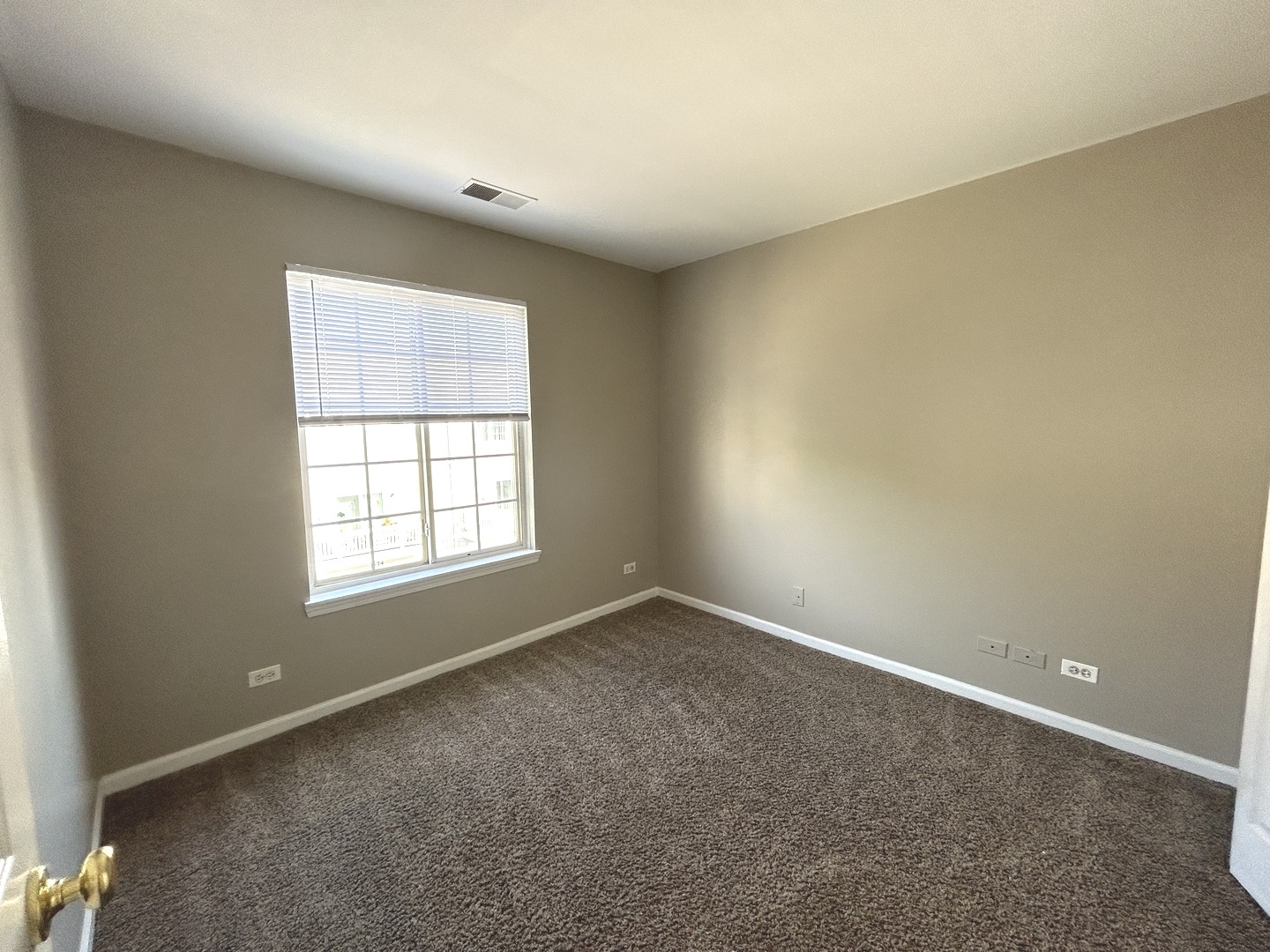 3466 Ravinia Circle, Unit 3466 Aurora, IL 60504 - Photo 16 of 24 an empty room with a window