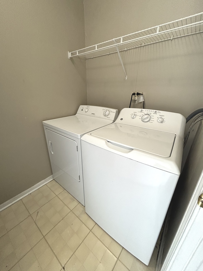 3466 Ravinia Circle, Unit 3466 Aurora, IL 60504 - Photo 23 of 24 a utility room with dryer and washer