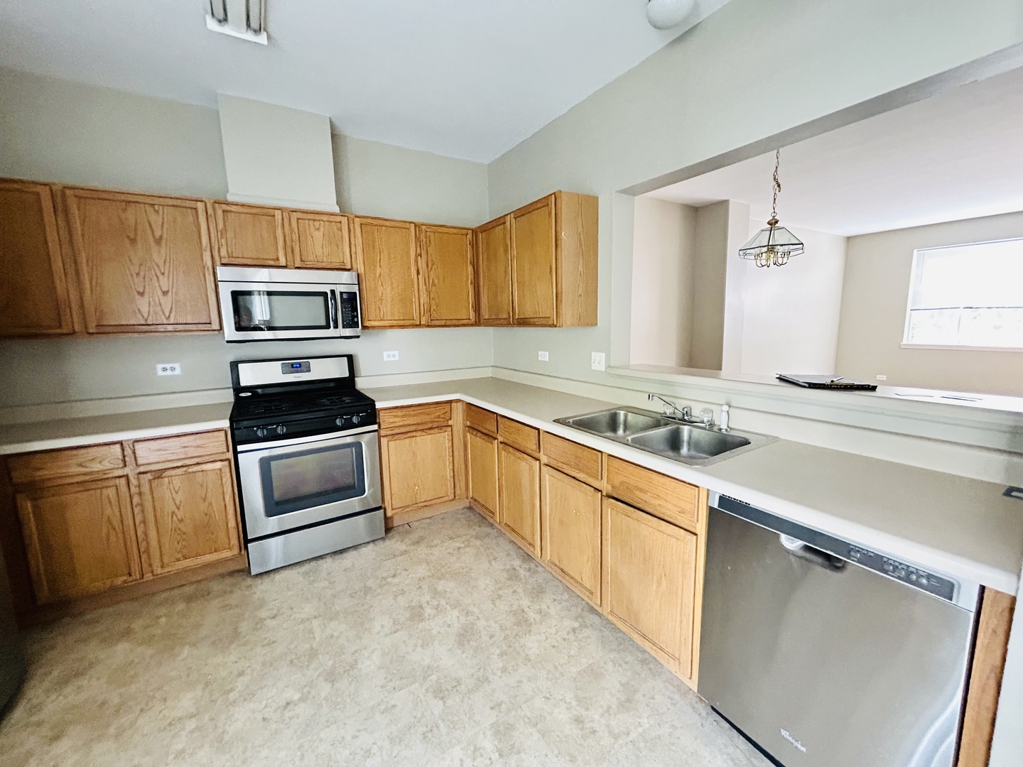 3466 Ravinia Circle, Unit 3466 Aurora, IL 60504 - Photo 3 of 24 a kitchen with a sink stove and microwave