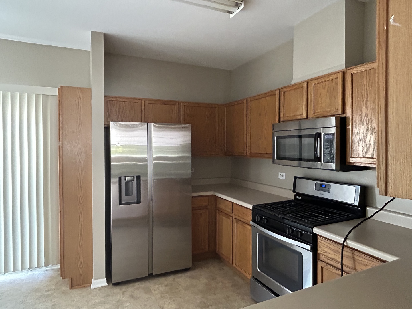 3466 Ravinia Circle, Unit 3466 Aurora, IL 60504 - Photo 4 of 24 a kitchen with stainless steel appliances granite countertop a stove a refrigerator and a microwave