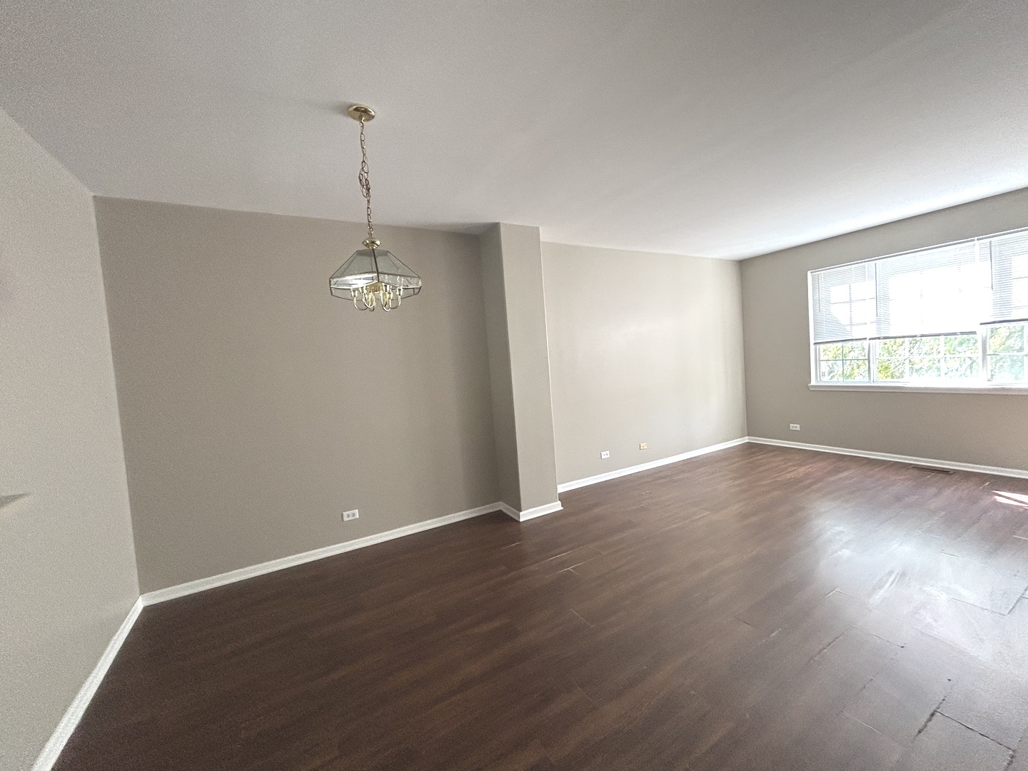 3466 Ravinia Circle, Unit 3466 Aurora, IL 60504 - Photo 5 of 24 an empty room with wooden floor windows and ceiling fan