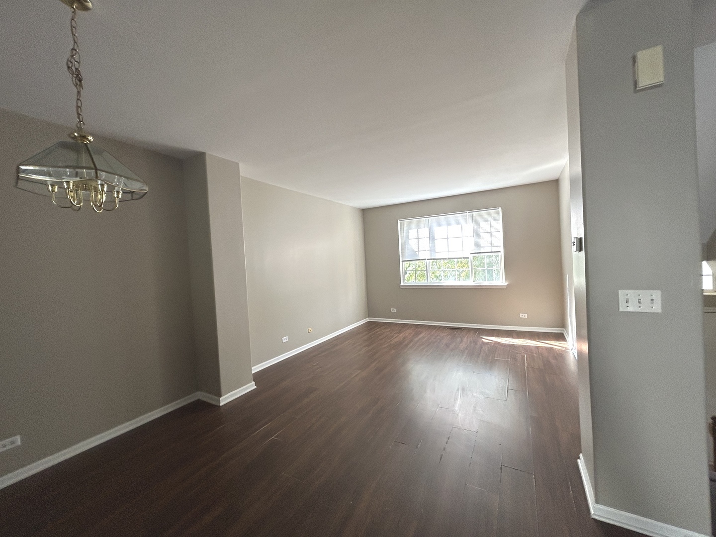 3466 Ravinia Circle, Unit 3466 Aurora, IL 60504 - Photo 7 of 24 an empty room with wooden floor windows and closet