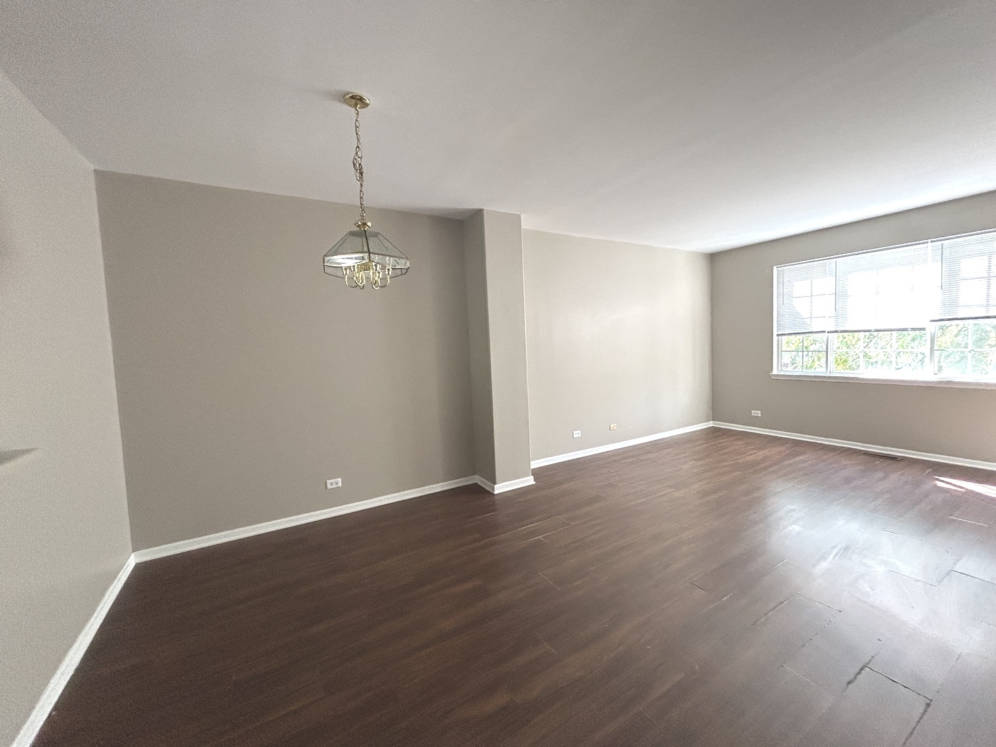 3466 Ravinia Circle, Unit 3466 Aurora, IL 60504 - Photo 8 of 24 an empty room with wooden floor and windows
