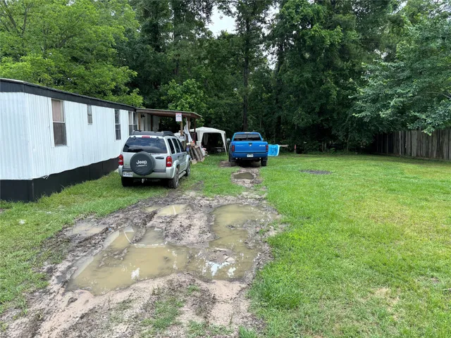 a view of a backyard with parked cars