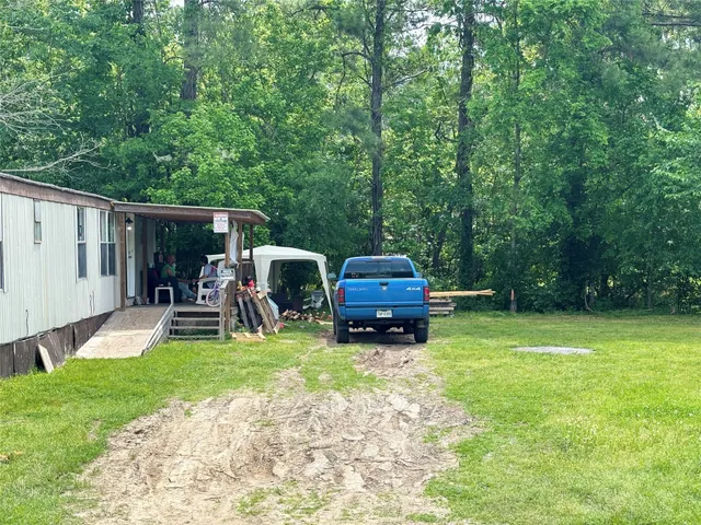a view of a backyard with table and chairs and a floor to ceiling window