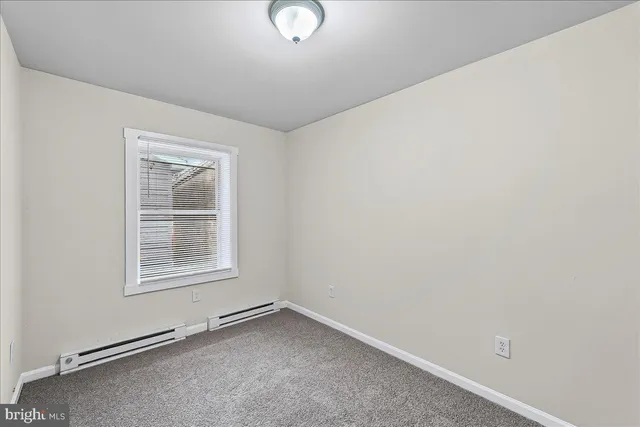 an empty room with a empty space and window