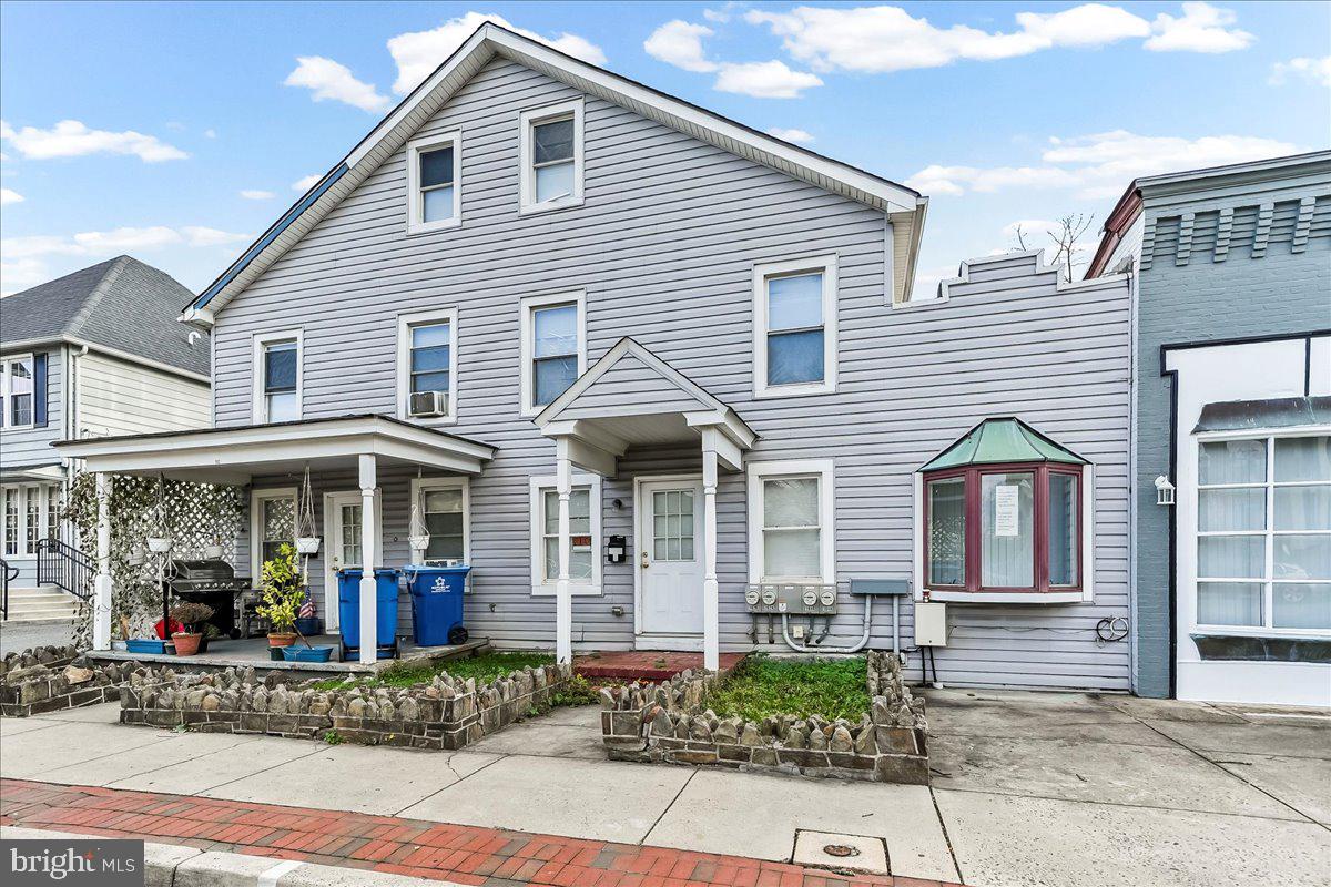 162 West Main Street Elkton, MD 21921 - Photo 2 of 41 a view of a white house with large windows and flower plants
