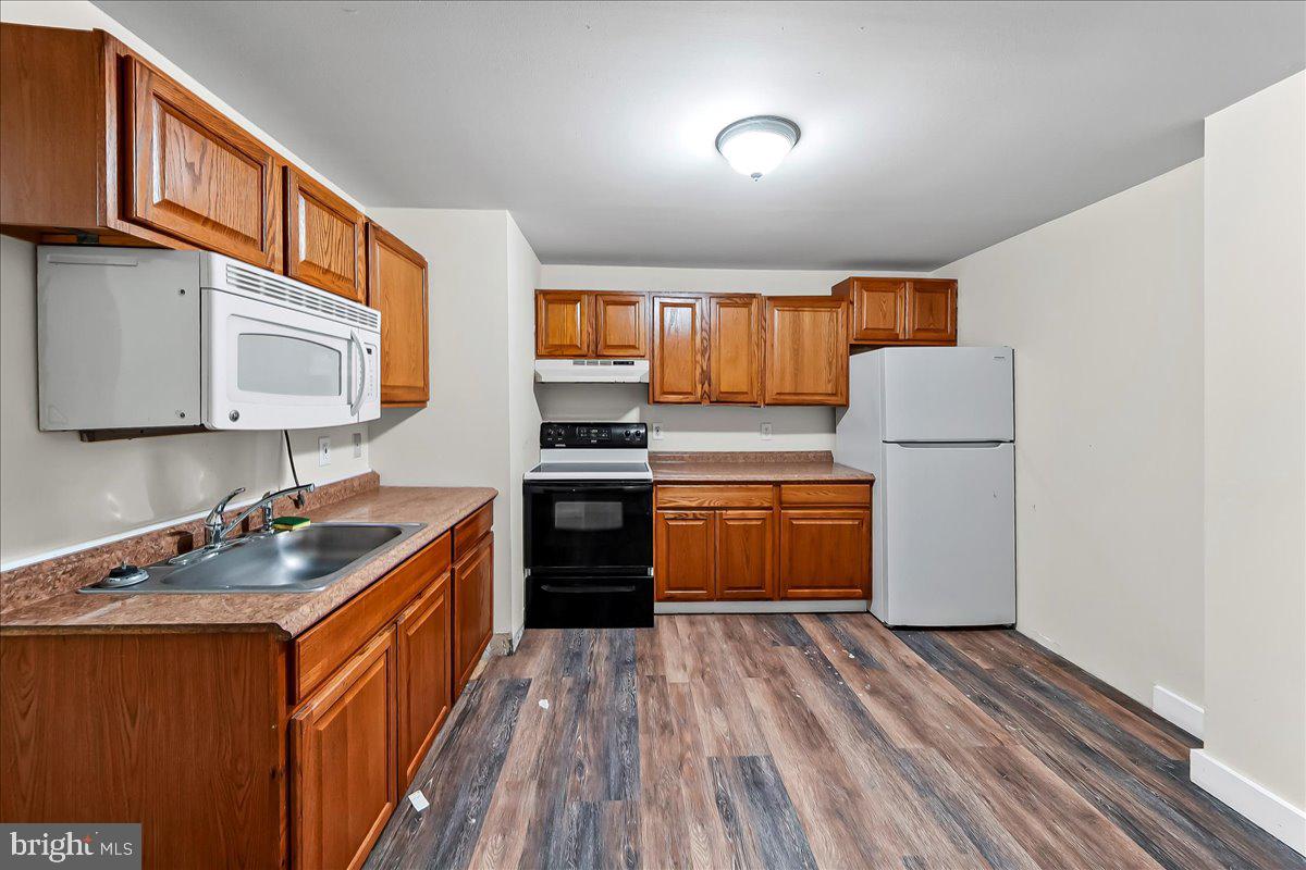 162 West Main Street Elkton, MD 21921 - Photo 21 of 41 a kitchen with stainless steel appliances granite countertop a sink stove and refrigerator