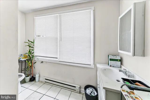 a living room with furniture a flat screen tv and a window