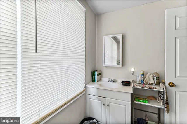 a bedroom with furniture and a air conditioner vent